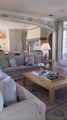 a living room filled with furniture and a large window next to it's entrance