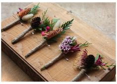 five flowers are arranged on a wooden board