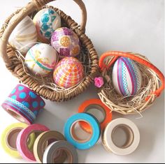 an assortment of decorative easter eggs in a basket with washi tapes on the floor