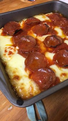 pepperoni and cheese pizza in a pan on a table