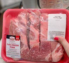 a package of raw meat sitting on top of a plastic container