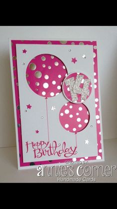 a happy birthday card with balloons and glitters on it's side, in pink and white