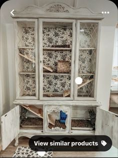 an old white china cabinet with glass doors