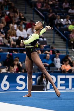 a female professional gymnastics player in action on the court