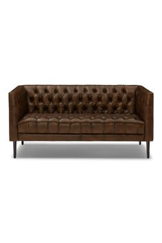 a brown leather couch with wooden legs and buttons on the back, against a white background