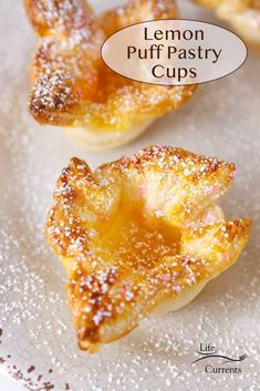 lemon puff pastry cups on a plate with powdered sugar