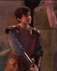 the young man is dressed in medieval clothing