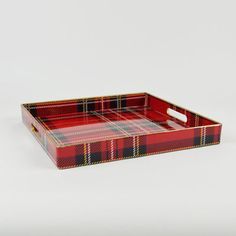 a red and black plaid tray with handles