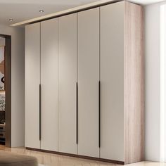 a living room filled with furniture and lots of white cupboards next to a window