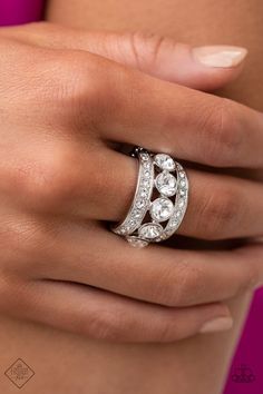 a woman's hand wearing a diamond ring