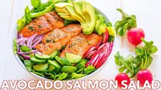 salmon salad with avocado and red onions in a bowl