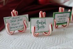 three candy canes with name tags on them sitting on a white tablecloth, and the caption reads keep your place