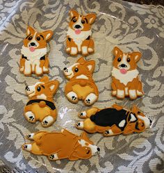 there are many decorated cookies that look like corgi puppies on the table