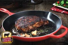 a steak is cooking in a red pan