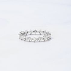 a white diamond ring on a white background