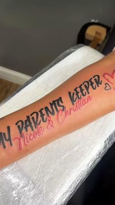 a person with a tattoo on their arm that says, my parents keeper nicole and christian