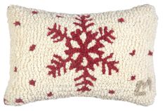 a red and white snowflake pillow on a white background, it is made out of wool