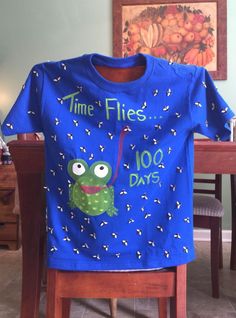 a blue t - shirt that says time flies with an image of a frog on it