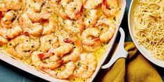 shrimp and pasta in a casserole dish next to a bowl of noodles on a table