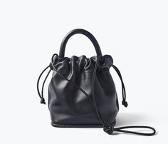 The effortless way to carry your everyday. Handcrafted with our signature black calf, the RUBY is your classic bucket bag finished with our iconic notched welt and top handle or crossbody strap for choice of carry. The microsuede-lined interior is secured with an adjustable drawstring to keep your essentials safe when you’re on the go. Black Leather Bucket Bag With Round Handle, Black Bucket Bag With Round Handle For Everyday, Everyday Black Bucket Bag With Round Handle, Realistic Outfits, Black Bucket Bag, Freda Salvador, Black Purse, Clean Makeup, Leather Cleaning