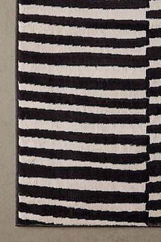 a black and white rug with vertical stripes