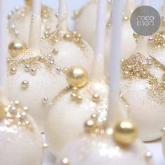 some white and gold cake pops with candles