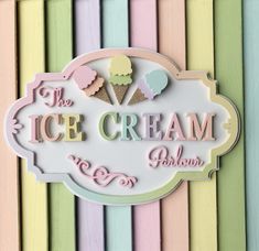 the ice cream parlor sign is painted in pastel colors