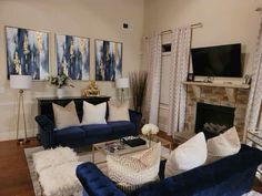 a living room filled with furniture and a flat screen tv mounted on the wall above a fireplace