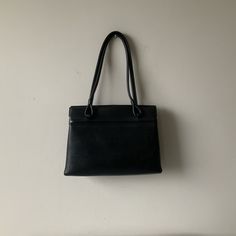 1950s black vinyl handbag. Super handbag! Vinyl covered inner metal frame. Piping detail to the front. Two top handles. Gusseted sides. Two open pockets, to either side of the main section that has a well fitting top catch. Black fabric lining with one inside side pocket. Good vintage condition for age, any flaws/blemishes will be minor. 10 x 7 x 2.5 inches, 14 inches from base to top of handles. For more vintage clothes and accessories, visit my shop https://www.etsy.com/uk/shop/coolclobber Wool Waistcoat, Parcel Service, Top Handle Bags, Vinyl Cover, Vintage Purse, Merino Wool Sweater, Vintage Clothes, Black Vinyl, Vintage Japanese