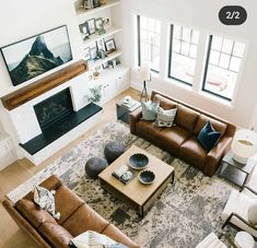 an overhead view of a living room with couches, coffee table, and fireplace