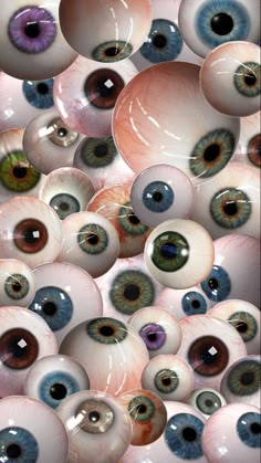 an image of many different colored eyeballs in the air with one looking at the camera