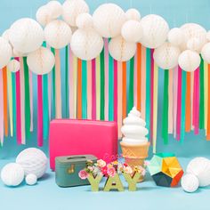 an ice cream sundae, cake and other items are on the blue background with colorful streamers