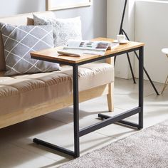 a living room scene with focus on the sofa and coffee table in the foreground