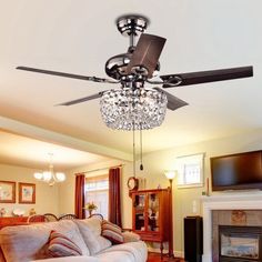 a living room with a couch and a ceiling fan that is hanging from the ceiling