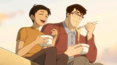 two people sitting on steps eating noodles and drinking coffee