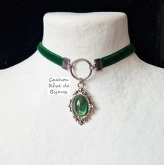 This Victorian-style choker takes on an elvish dimension with its moss green cabochon which reveals all its depth in the light. -------------- Details ---------------- - Oval decorated, polished and glossy glass cabochon: 13x18mm - Green decor with moss effect, revisited by me in my workshop - Victorian pendant in antique silver metal: 45x25mm - Choker in matching green velvet and stainless steel findings: 32-39cm with the extension to adjust to your convenience (contact me for another length) - Gothic Green Jewelry For Gifts, Green Gothic Jewelry For Gifts, Green Gothic Jewelry Gift, Green Metal Choker As A Gift, Green Metal Choker For Gift, Green Gothic Style Jewelry Gift, Forest Elf, Victorian Pendants, Choker Pendant