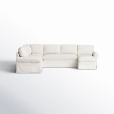 a white sectional couch sitting on top of a white floor