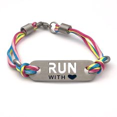 a bracelet that says run with love on it