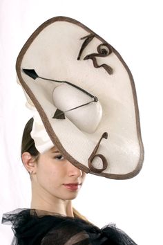 "A Statement Ascot Fascinator hat, Kentucky derby fascinator, Melbourne cup hat inspired by Salvador Dali's \"Nobility of time\". This extraordinary \"Watch\" hat is made from ivory paper, brown sinamey numbers and black feather hands/arrows. there is also a big bow-knot and for better stability the hat is secured with milliner elastic. Unique hat! This amazing hat is made to order - please let us 1-2 weeks to recreate it Please send me your head size when ordering so we can adjust it for you. A Navy Fascinator, Racing Fashion, Statement Hat, Mad Hat, Kentucky Derby Fascinator, Royal Ascot Hats, Derby Fascinator, Ascot Hats, Hat Fascinator