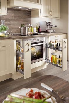 an open oven door in a kitchen with white cabinets