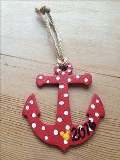 a red and white anchor ornament with polka dots on it's side