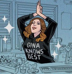 a woman with her hands up in the air while wearing a black shirt that says gina knows best