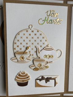 a card with some cut outs on top of it, including a teapot and cupcake