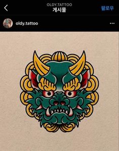 an old tattoo sticker with a dragon head on it's face and two horns