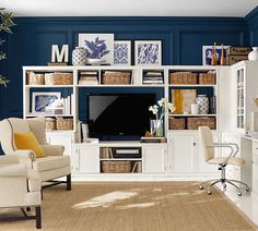 a living room with blue walls and white furniture