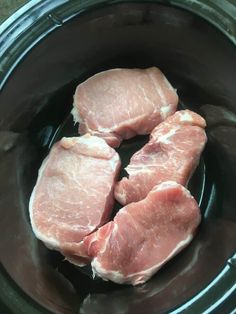 three pieces of raw meat are in the slow cooker, ready to be cooked