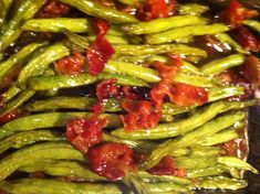 asparagus with tomatoes and sauce in a pan ready to be cooked on the stove