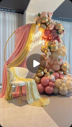 the balloon tree is decorated with gold, pink and white balloons