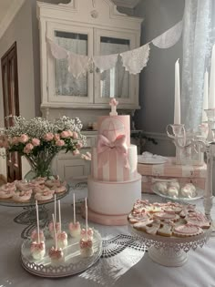 a table topped with cakes and cupcakes covered in frosting