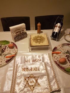 a table topped with plates and cakes covered in frosting